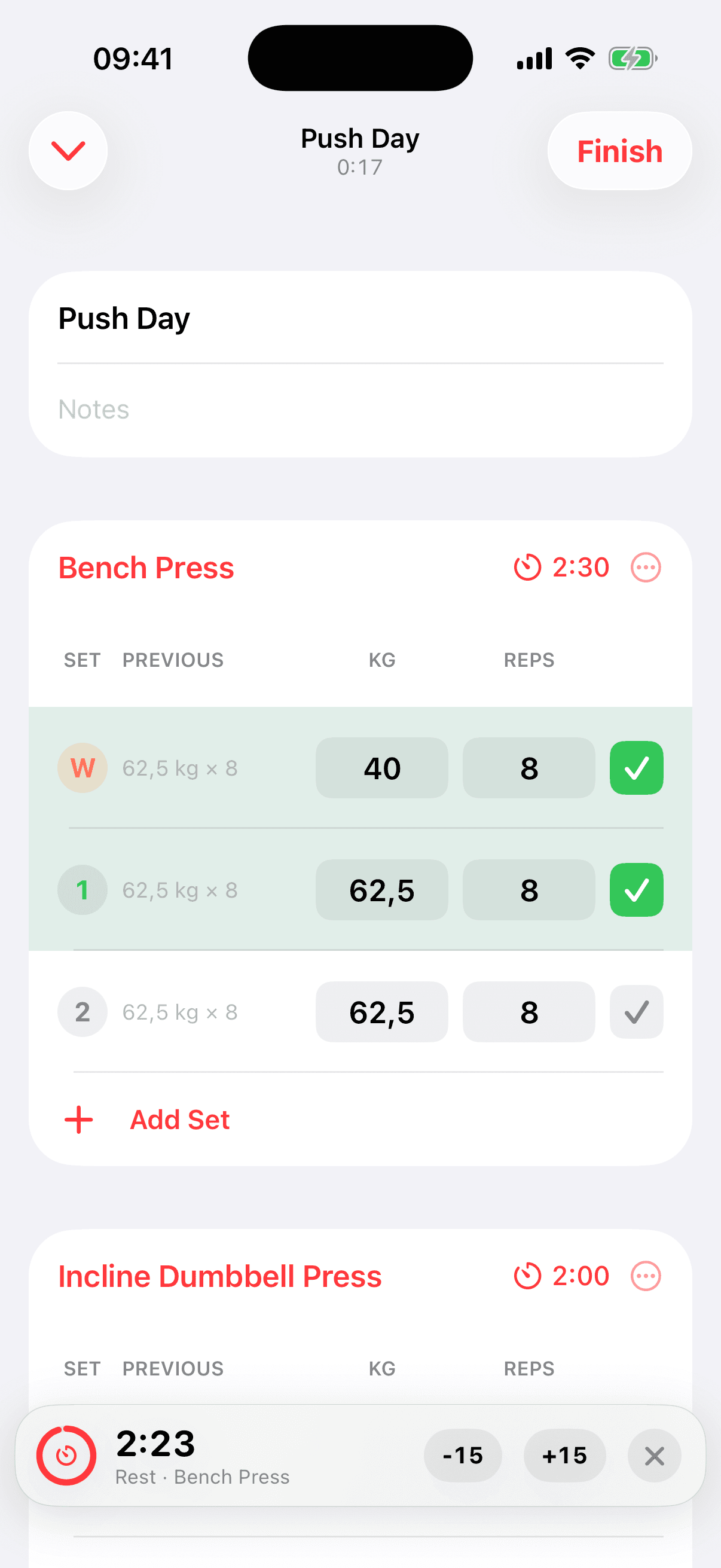 Live Push Day workout with a completed warm-up set labeled W, working sets, previous values, and a rest timer